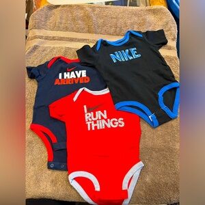 (3) Nike onesies. Size 0-6M